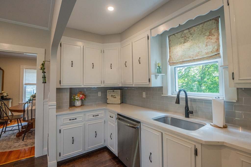5 Florence Street Danvers, MA 01923 - Photo 18 of 41 a kitchen with stainless steel appliances white cabinets and a window