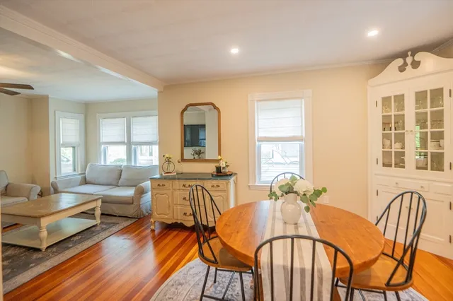 a living room with furniture dining table and wooden floor