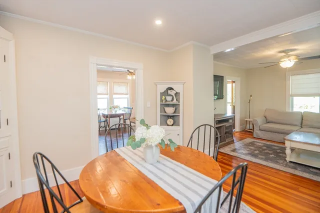 a dining room with furniture and wooden floor