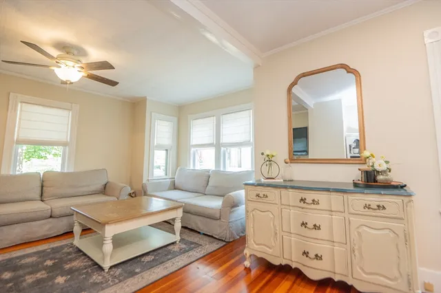 a living room with furniture and wooden floor