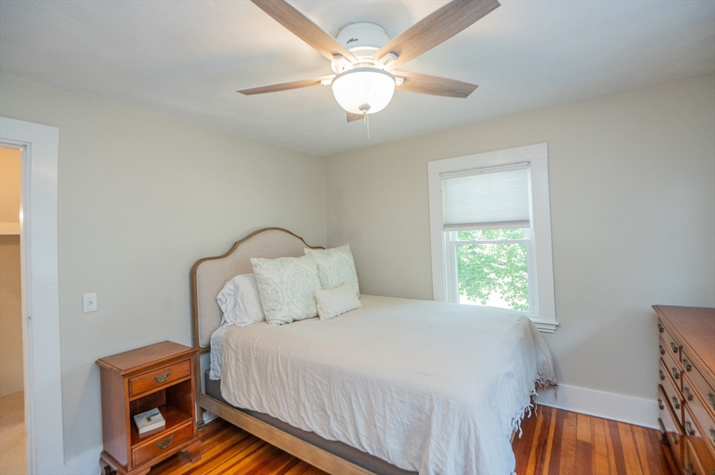 5 Florence Street Danvers, MA 01923 - Photo 27 of 41 a bedroom with a bed and a chandelier