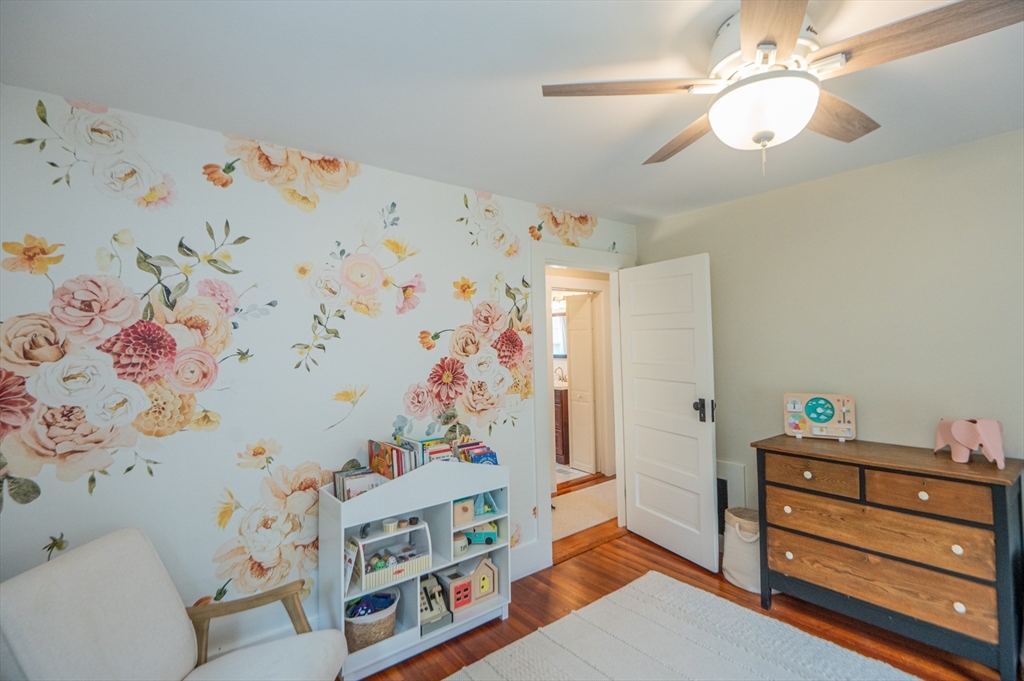 5 Florence Street Danvers, MA 01923 - Photo 36 of 41 a bedroom with baby bed toys and paintings on the wall