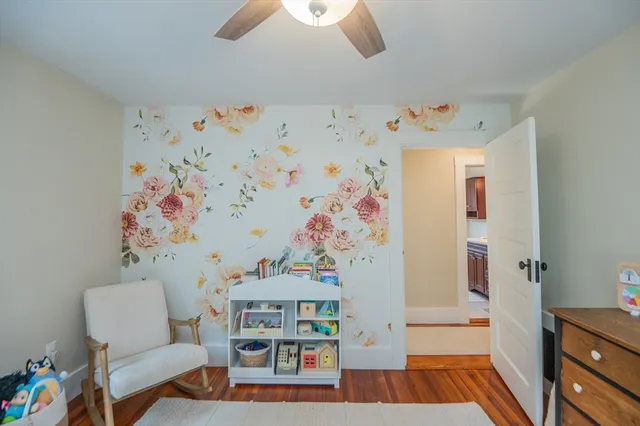 a bedroom with furniture and a chandelier fan