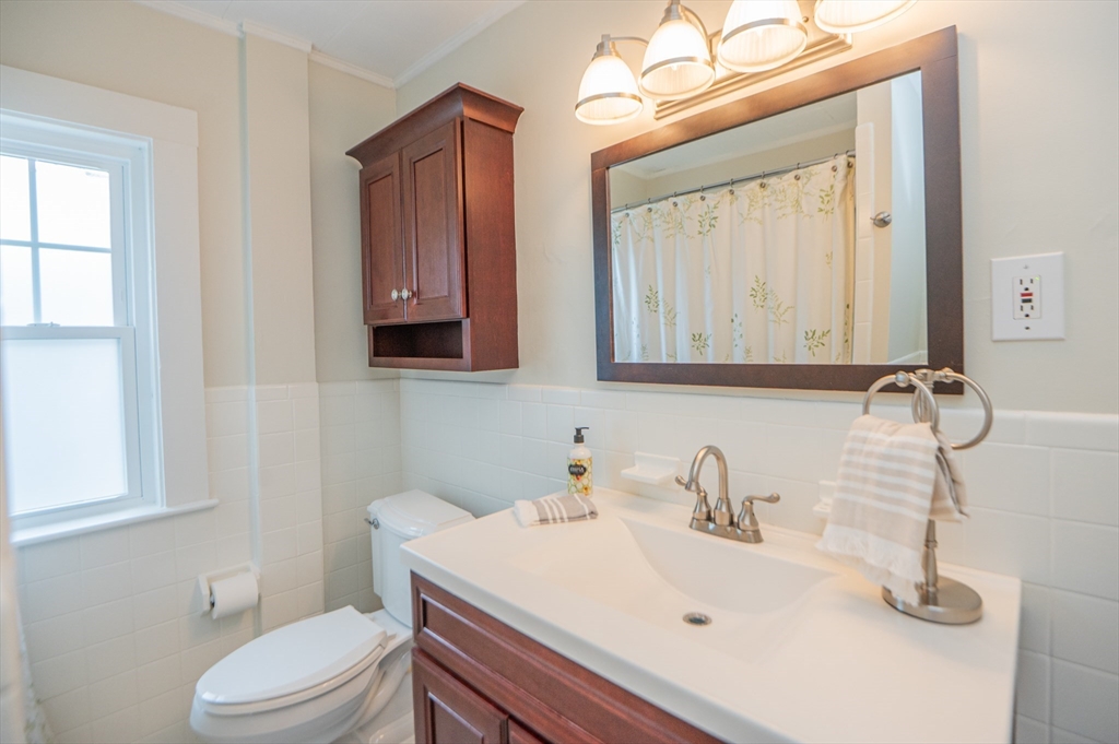 5 Florence Street Danvers, MA 01923 - Photo 39 of 41 a bathroom with a sink a toilet and mirror