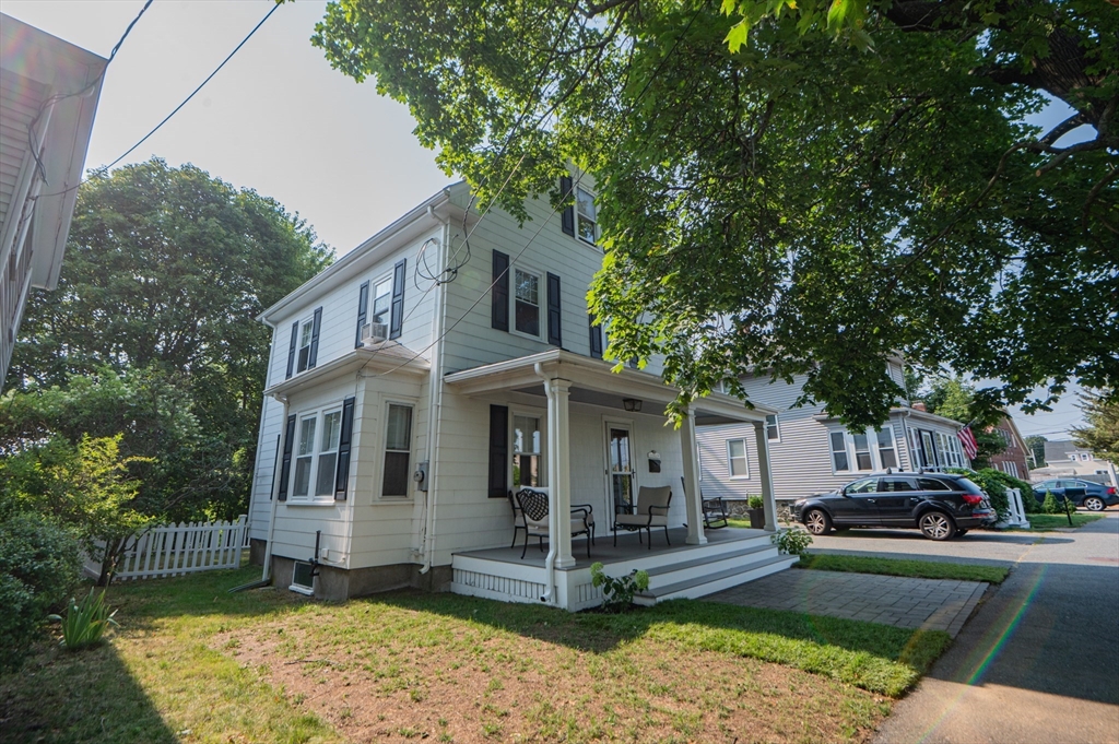 5 Florence Street Danvers, MA 01923 - Photo 5 of 41 a view of a white house with a yard plants and large tree