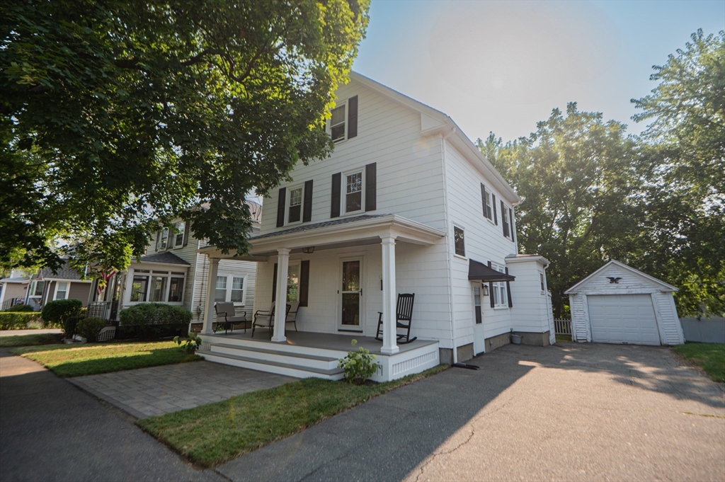 5 Florence Street Danvers, MA 01923 - Photo 6 of 41 a view of a white house with a large windows and large tree and plants