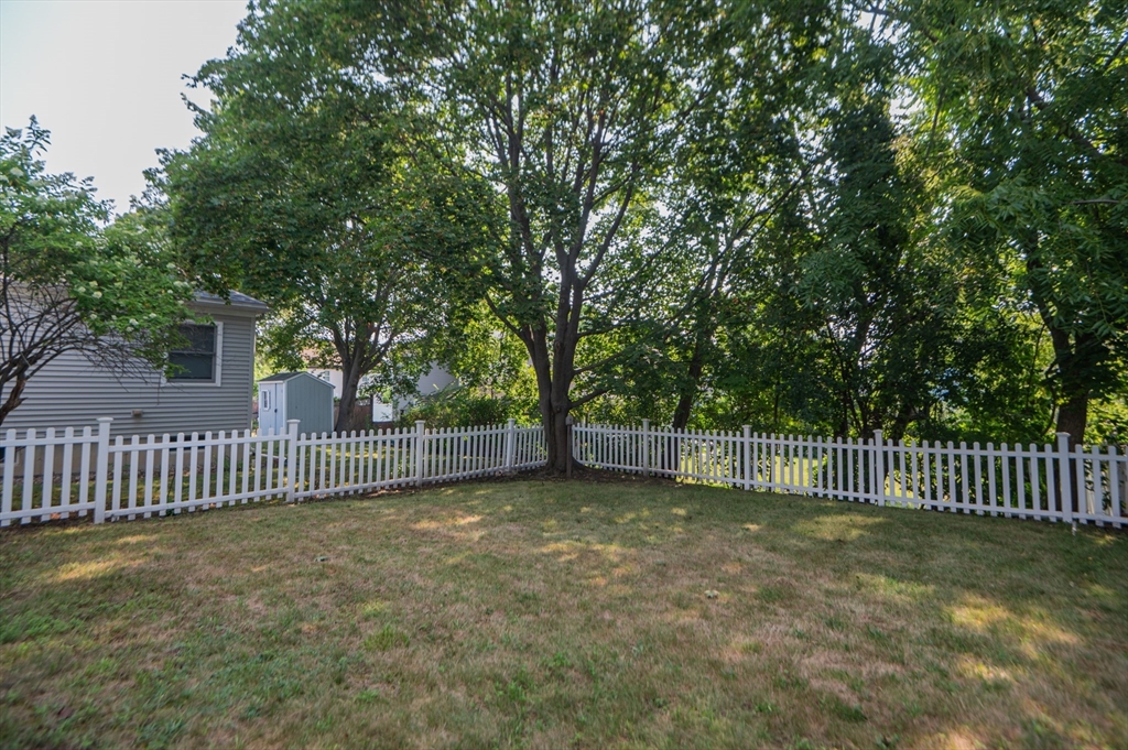 5 Florence Street Danvers, MA 01923 - Photo 9 of 41 a view of a yard with wooden fence and trees