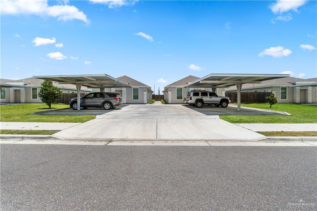 a view of building with cars parked in front of it