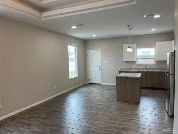 a view of kitchen with sink and wooden floor