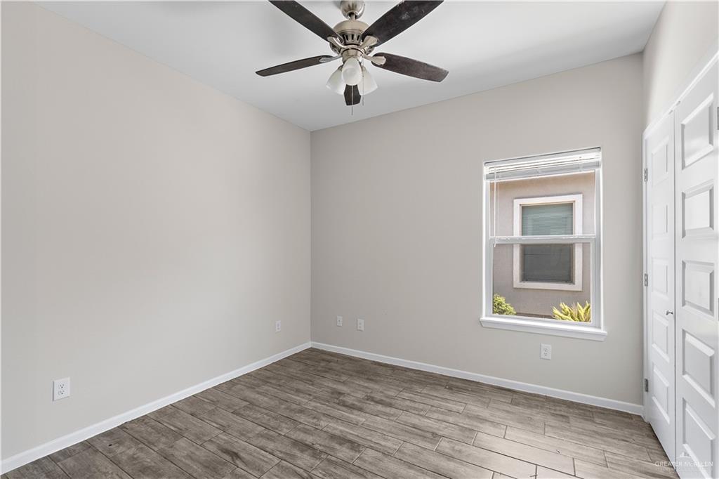 912-3 Kentucky Street Alton, TX 78573 - Photo 9 of 17 wooden floor in an empty room with a window