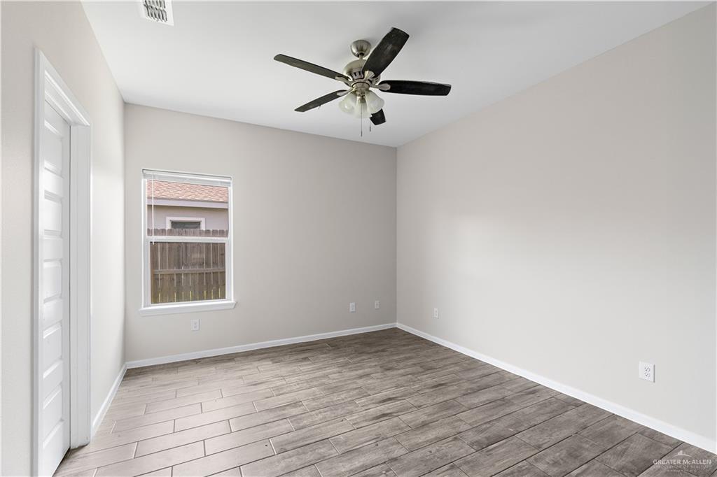 912-3 Kentucky Street Alton, TX 78573 - Photo 10 of 17 an empty room with wooden floor closet and windows