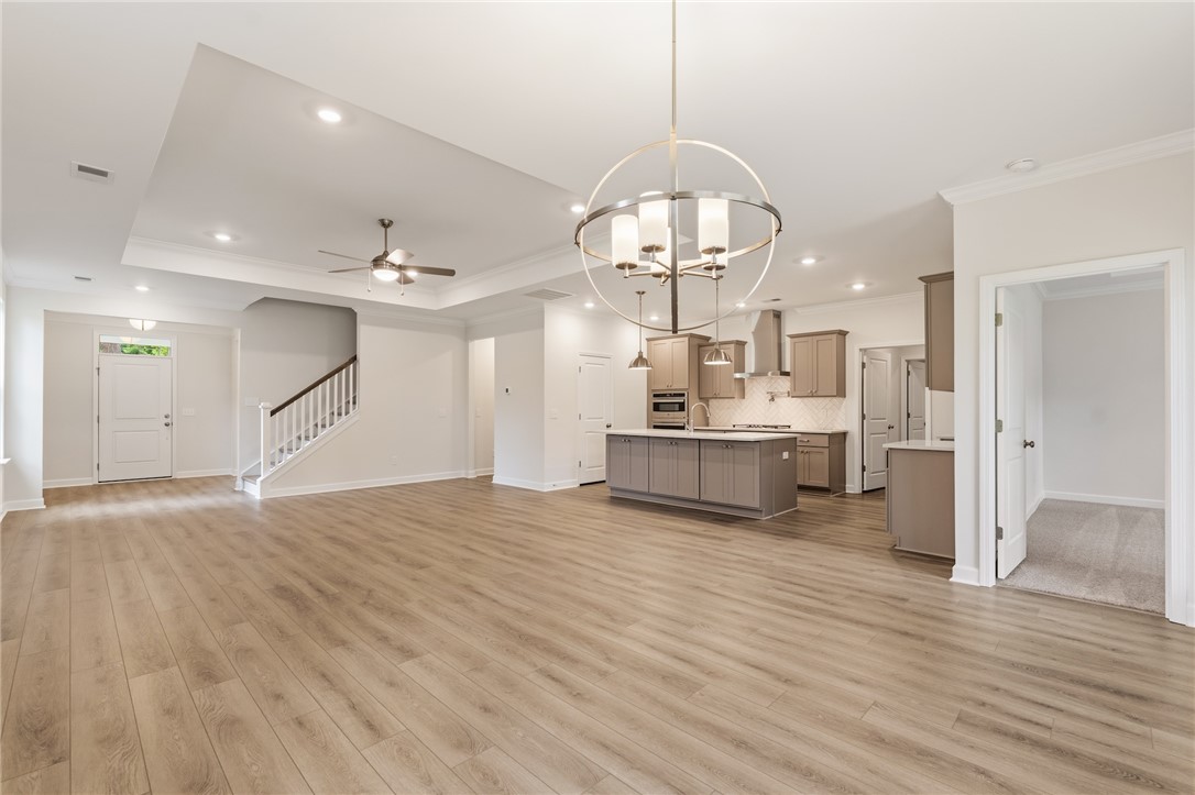 110 Lakeside Drive Anderson, SC 29621 - Photo 12 of 34 This expansive open concept living space features a modern kitchen and inviting hardwood flooring.