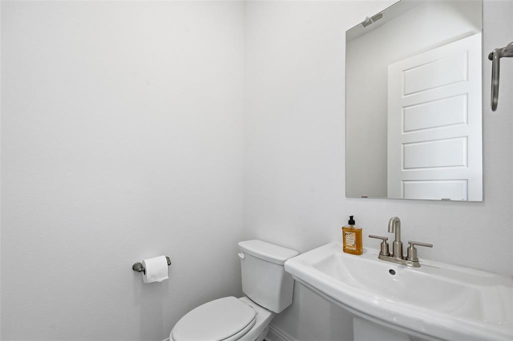 2533 Brunswick Way, Unit 2533 Allen, TX 75013 - Photo 10 of 24 a bathroom with a toilet sink and mirror