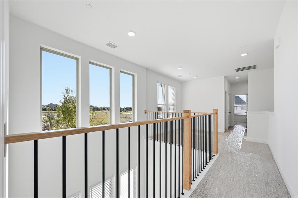 2533 Brunswick Way, Unit 2533 Allen, TX 75013 - Photo 13 of 24 a view of hallway with a large window and stairs