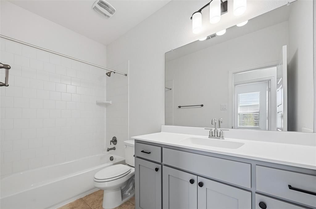 2533 Brunswick Way, Unit 2533 Allen, TX 75013 - Photo 21 of 24 a bathroom with a sink a toilet and shower