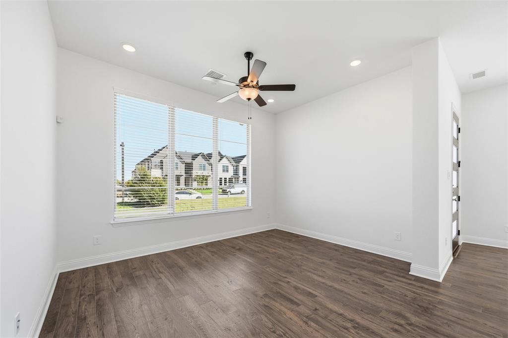 2533 Brunswick Way, Unit 2533 Allen, TX 75013 - Photo 3 of 24 an empty room with wooden floor chandelier fan and windows