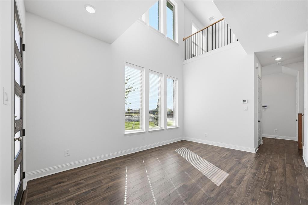 2533 Brunswick Way, Unit 2533 Allen, TX 75013 - Photo 8 of 24 an empty room with wooden floor and windows
