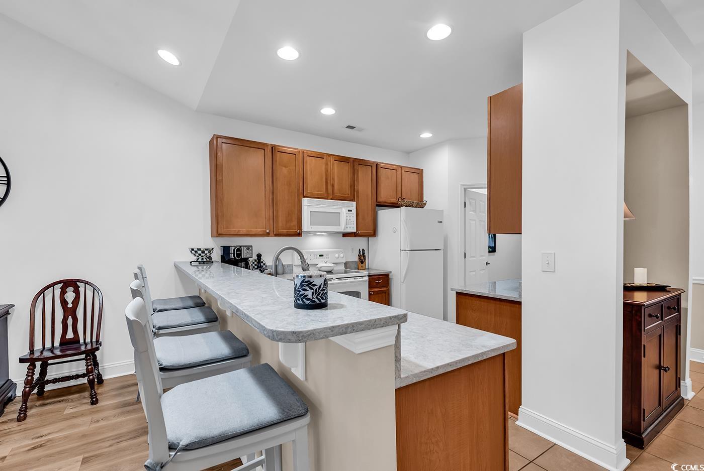 637 Botany Loop, Unit 637 Murrells Inlet, SC 29576 - Photo 8 of 40 Kitchen with white appliances, a breakfast bar, br