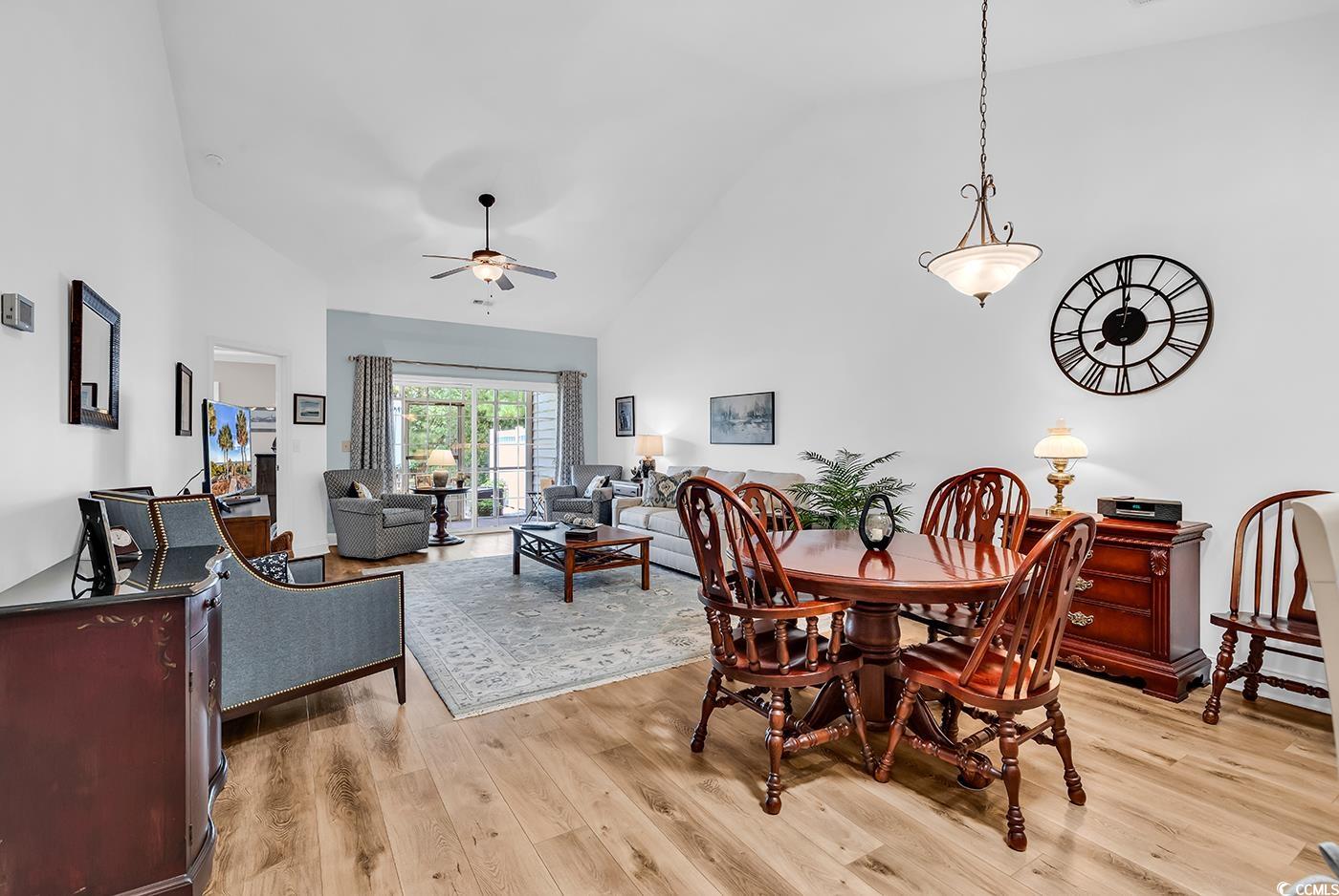 637 Botany Loop, Unit 637 Murrells Inlet, SC 29576 - Photo 10 of 40 Dining area with high vaulted ceiling, light wood-
