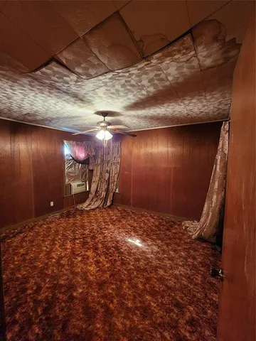 a view of a big room with wooden floor and windows