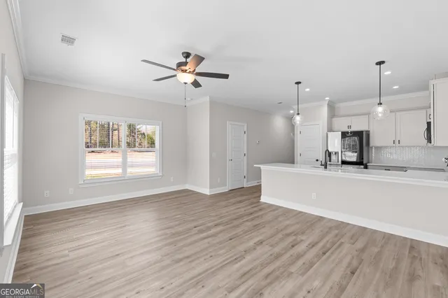 a view of kitchen with sink and wooden floor