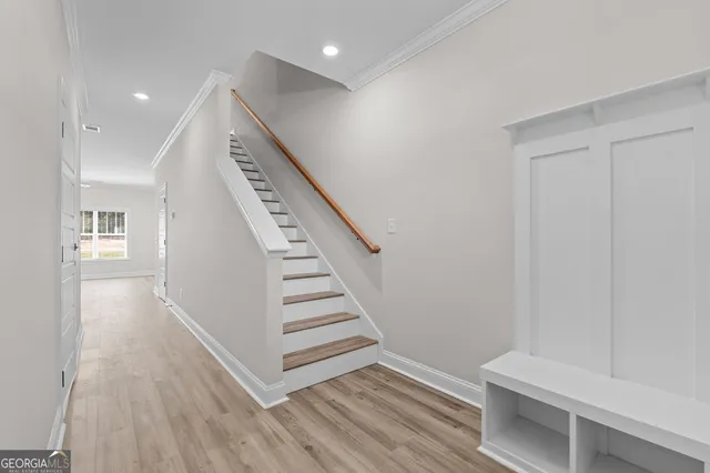 a view of entryway with stairs and wooden floor