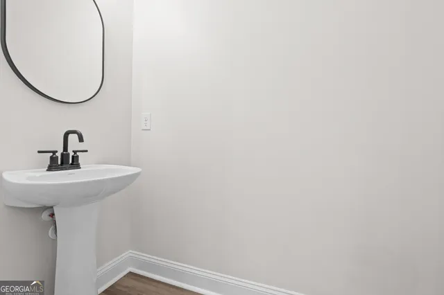 a bathroom with a sink and mirror