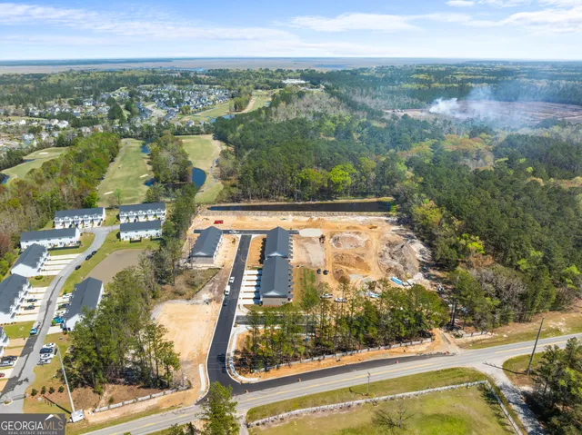 an aerial view of residential houses with outdoor space and street view