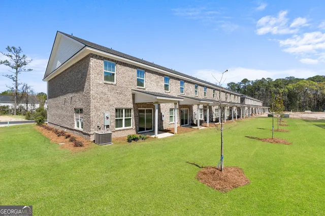 a front view of a house with a yard table and chairs