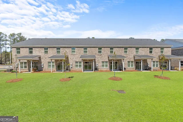 a front view of a house with swimming pool having outdoor seating