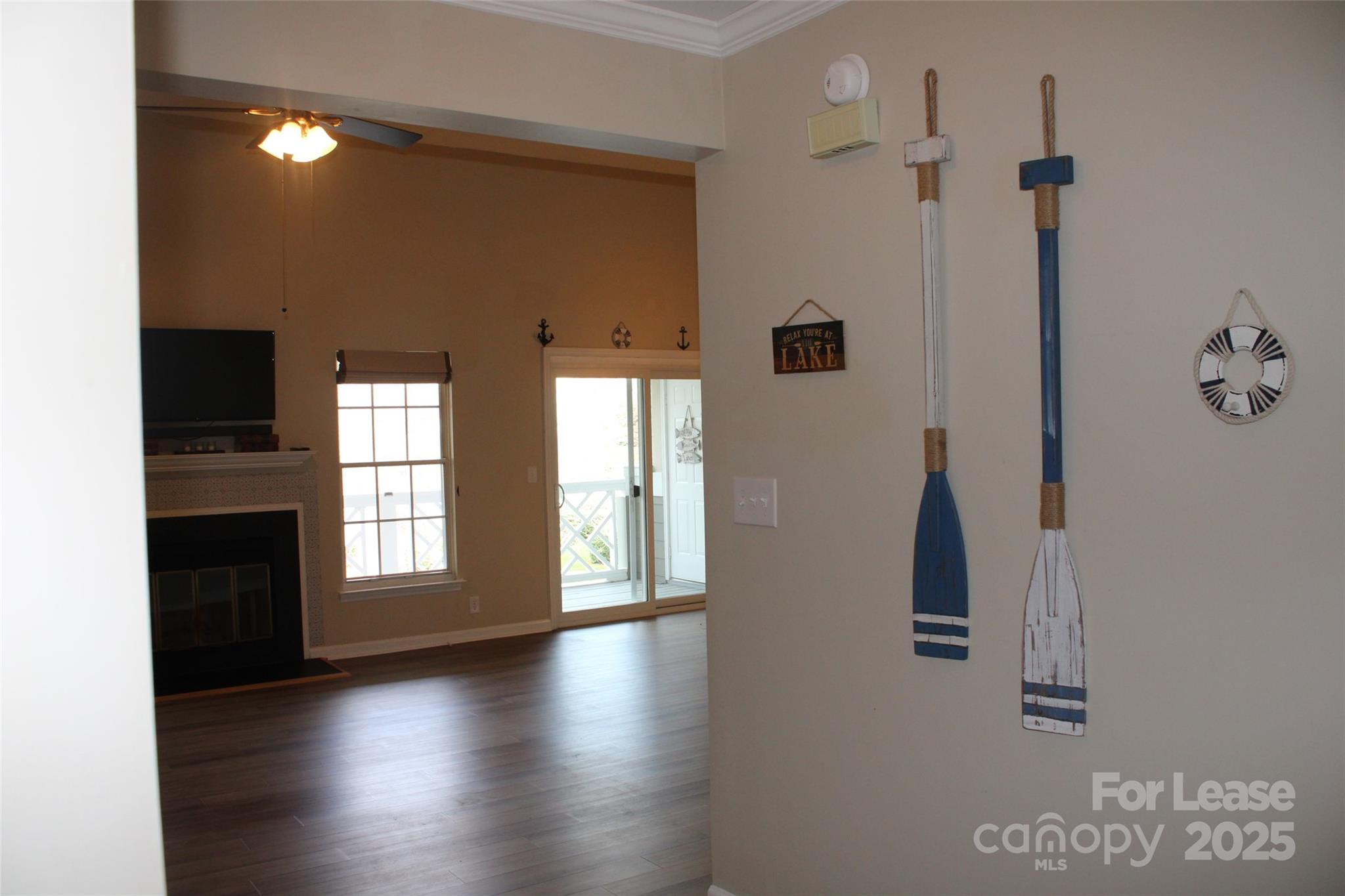19839 Henderson Road, Unit M Cornelius, NC 28031 - Photo 11 of 23 a view of an empty room with a window and wooden floor