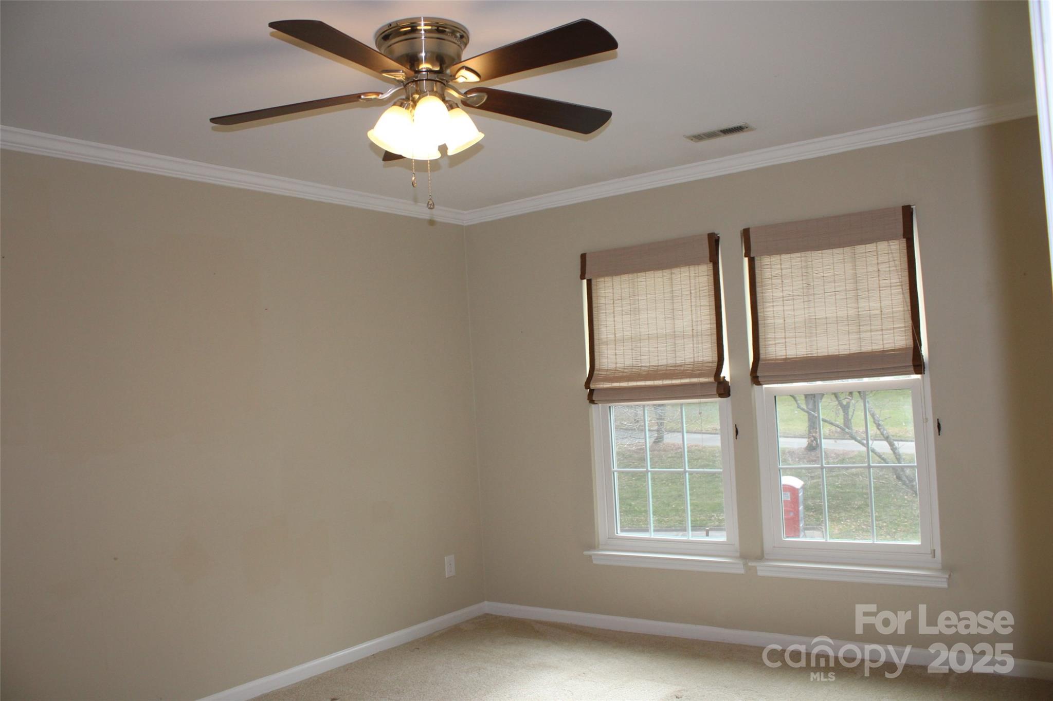 19839 Henderson Road, Unit M Cornelius, NC 28031 - Photo 13 of 23 an empty room with windows and ceiling fan