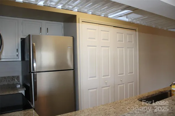 a white refrigerator freezer and a wooden floor