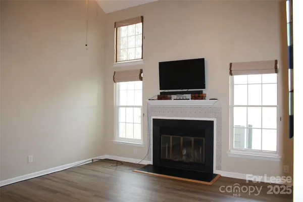 a living room with a fireplace and a flat screen tv