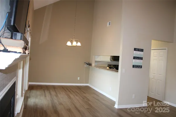 a kitchen with a refrigerator and a stove top oven