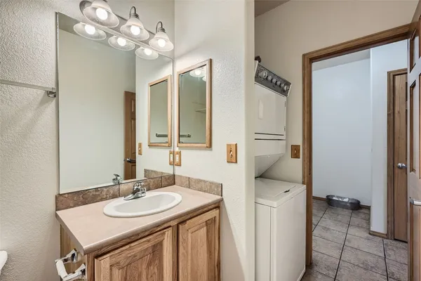 a bathroom with a sink a light fixture and a mirror