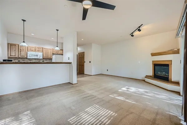a view of a kitchen with a sink and a fireplace