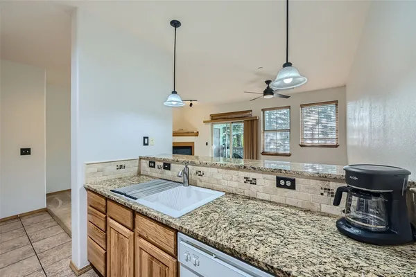 a kitchen with sink stove and granite counter top
