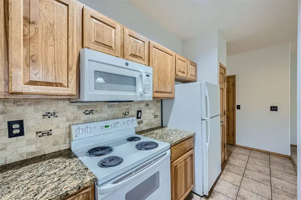 a kitchen with a stove and a refrigerator
