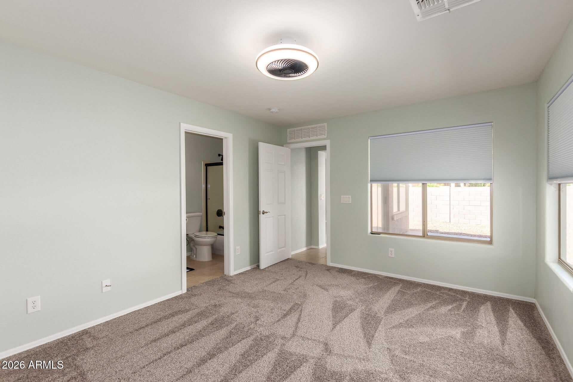 17618 West Calavar Road Surprise, AZ 85388 - Photo 14 of 24 a view of an empty room with a window