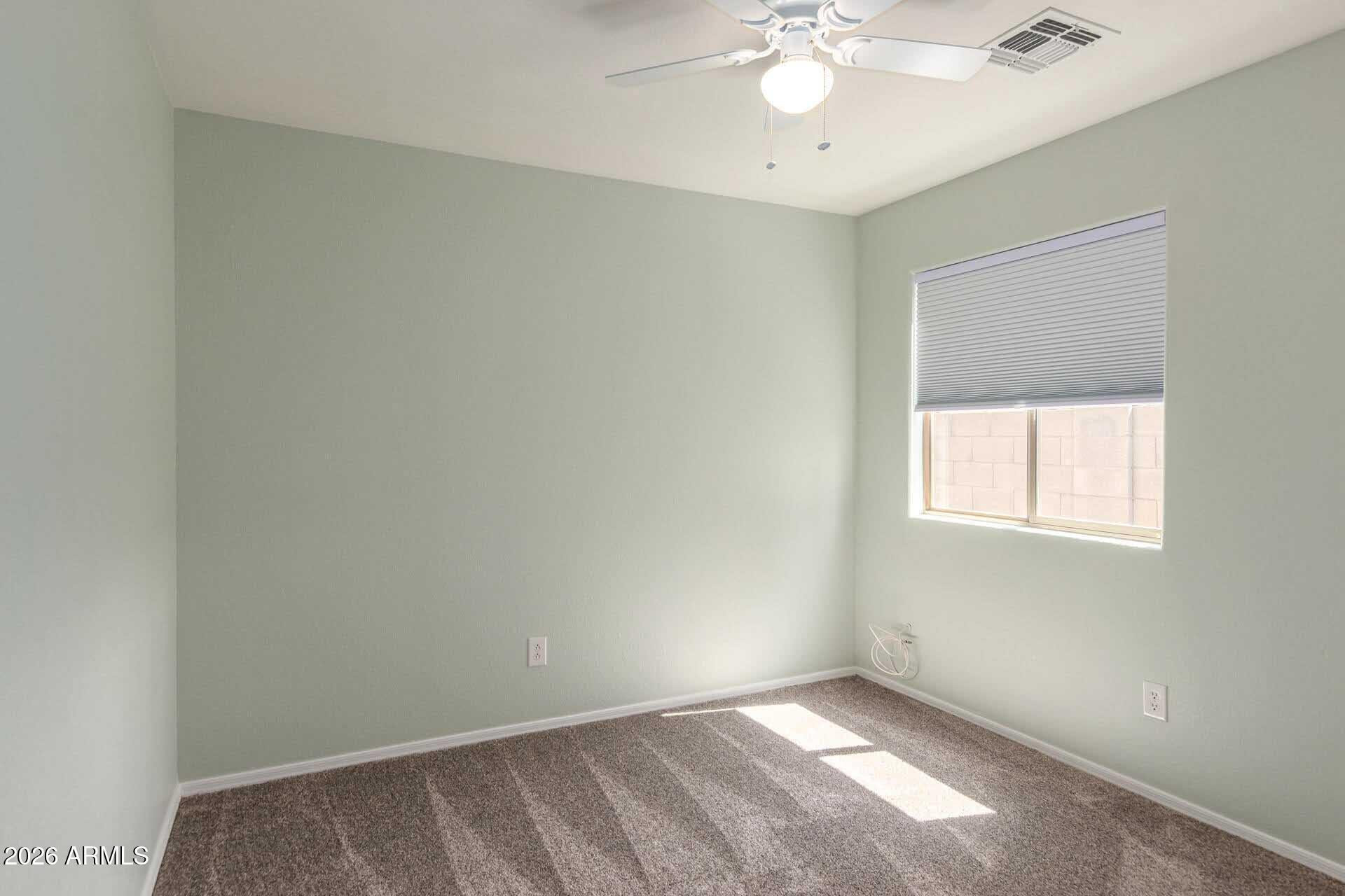 17618 West Calavar Road Surprise, AZ 85388 - Photo 16 of 24 an empty room with a window