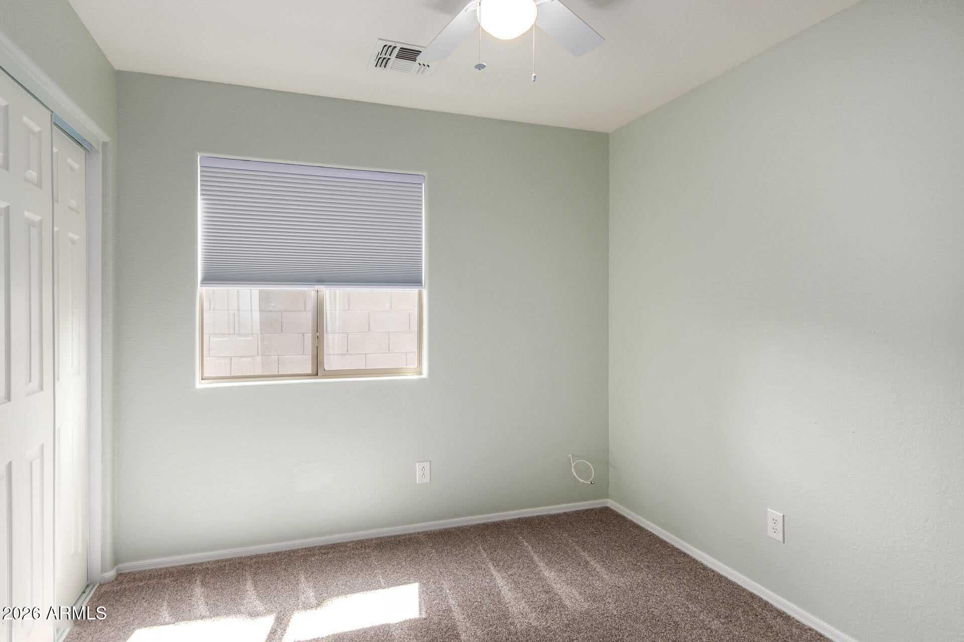17618 West Calavar Road Surprise, AZ 85388 - Photo 18 of 24 an empty room with a window