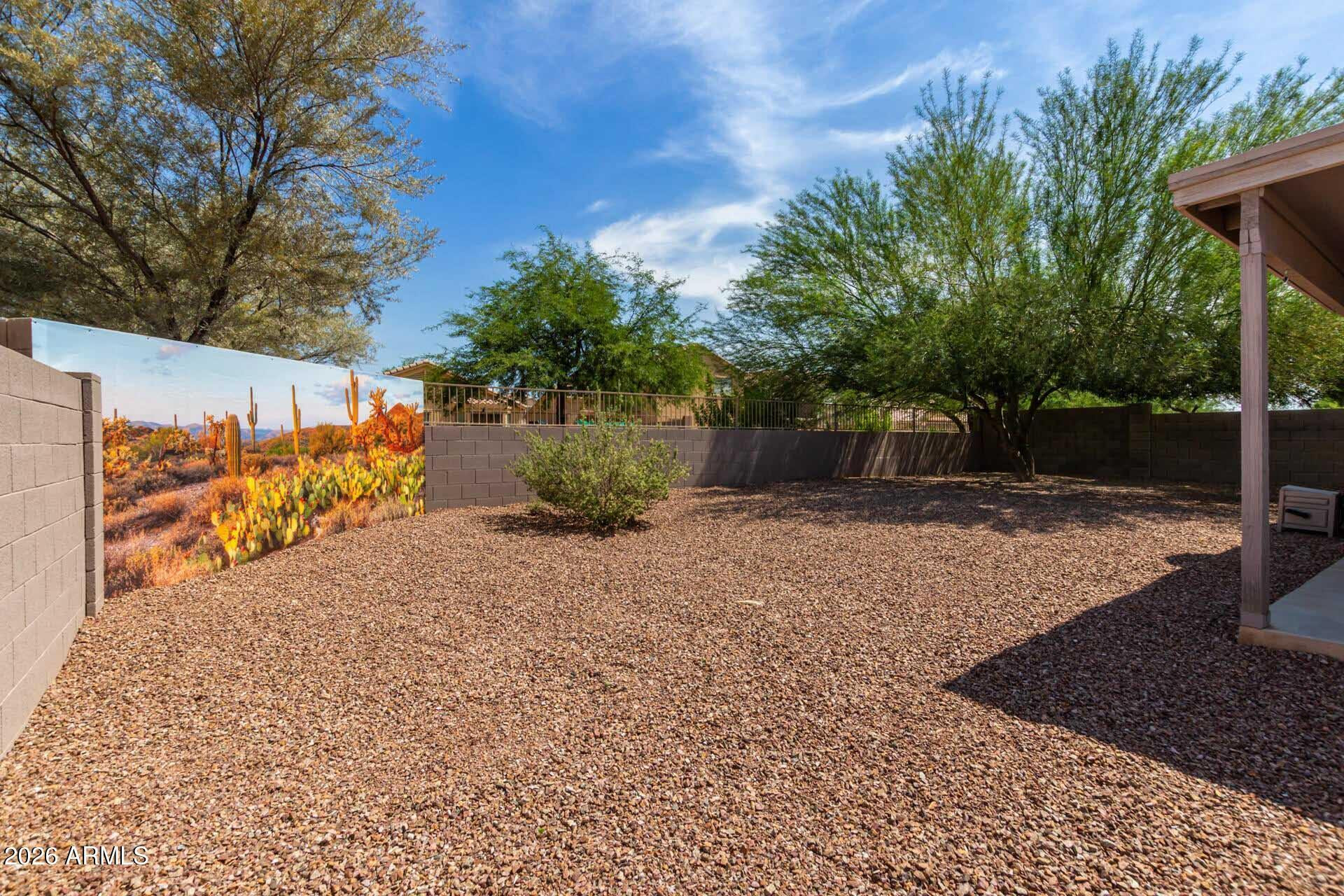 17618 West Calavar Road Surprise, AZ 85388 - Photo 2 of 24 a view of a backyard with potted plants