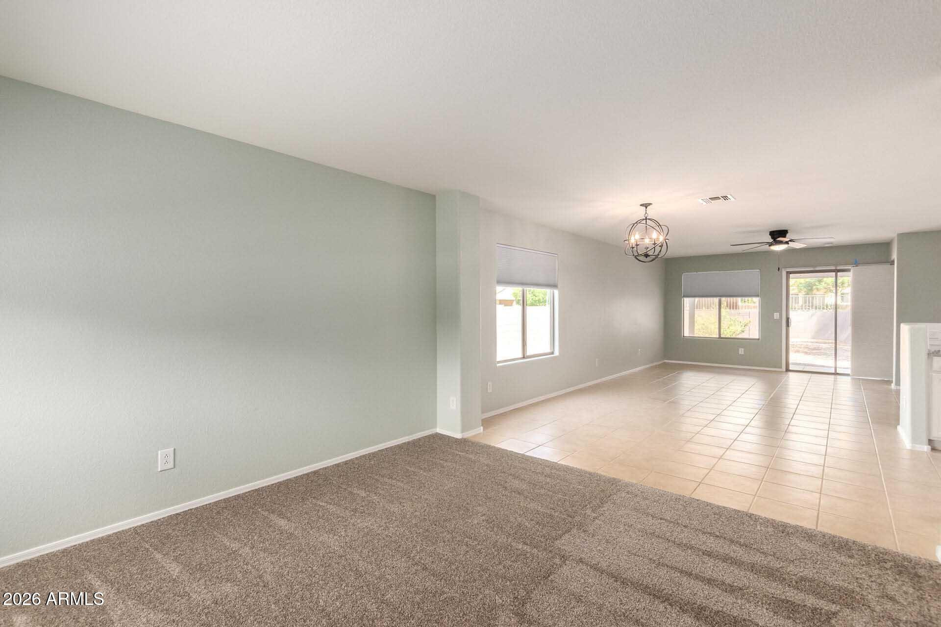 17618 West Calavar Road Surprise, AZ 85388 - Photo 3 of 24 wooden floor in an empty room with a window