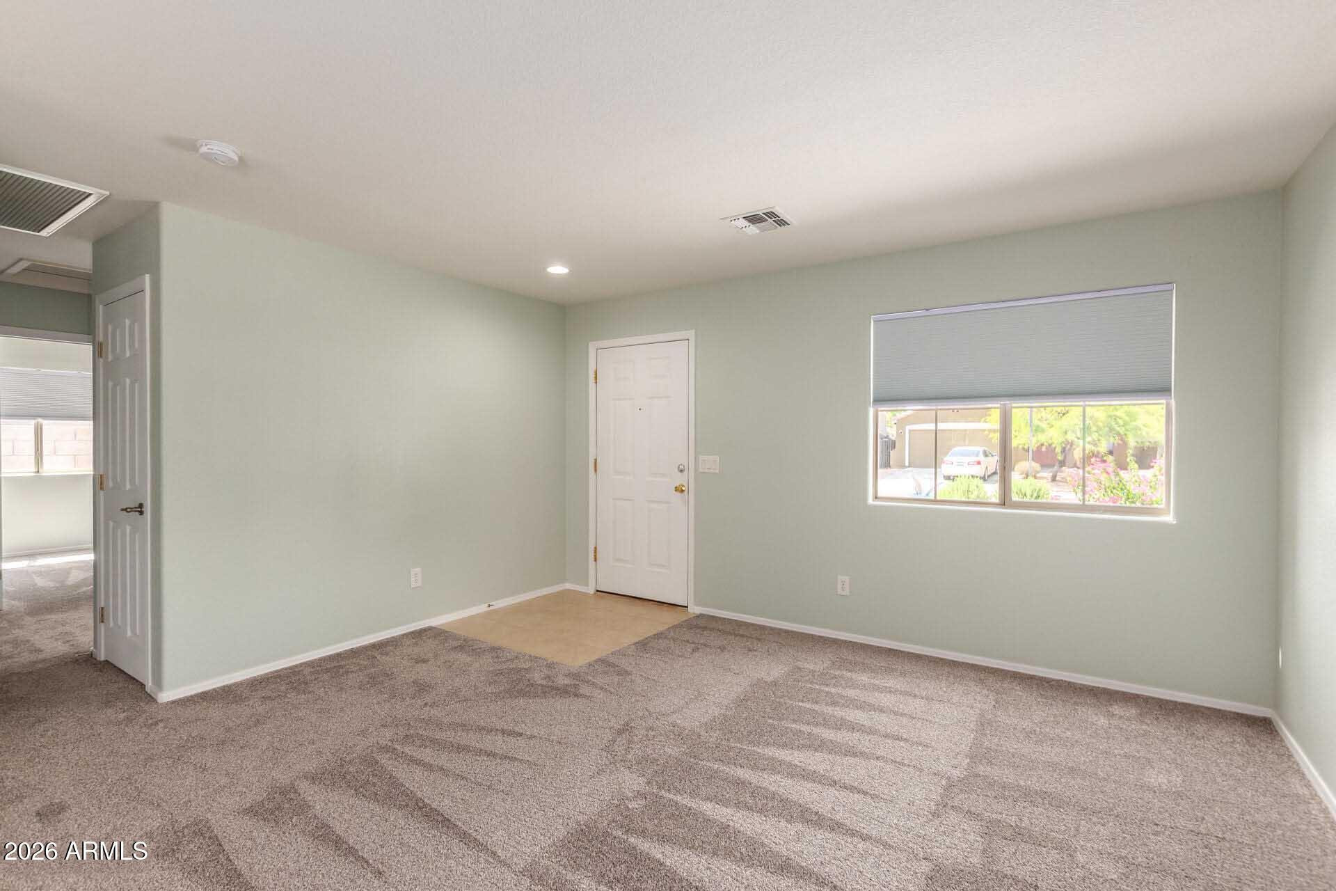 17618 West Calavar Road Surprise, AZ 85388 - Photo 5 of 24 a view of an empty room with a window