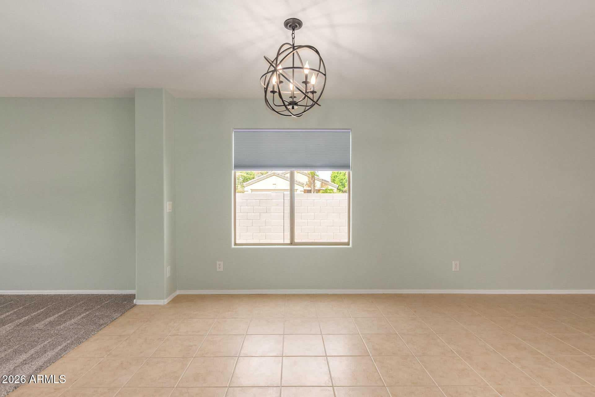 17618 West Calavar Road Surprise, AZ 85388 - Photo 6 of 24 a view of a hallway with a chandelier
