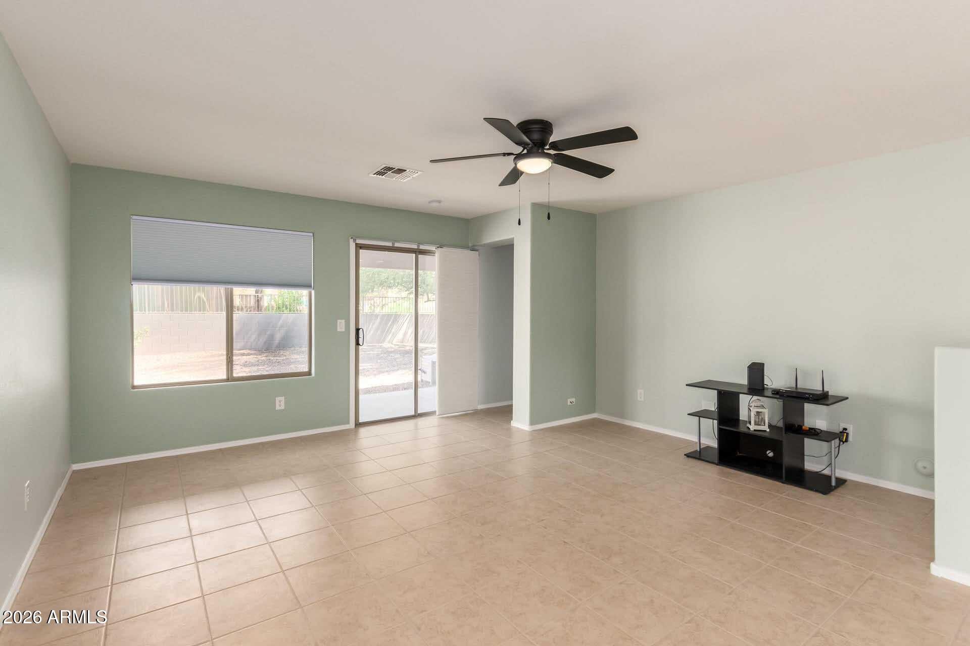 17618 West Calavar Road Surprise, AZ 85388 - Photo 7 of 24 a view of room with a ceiling fan and window