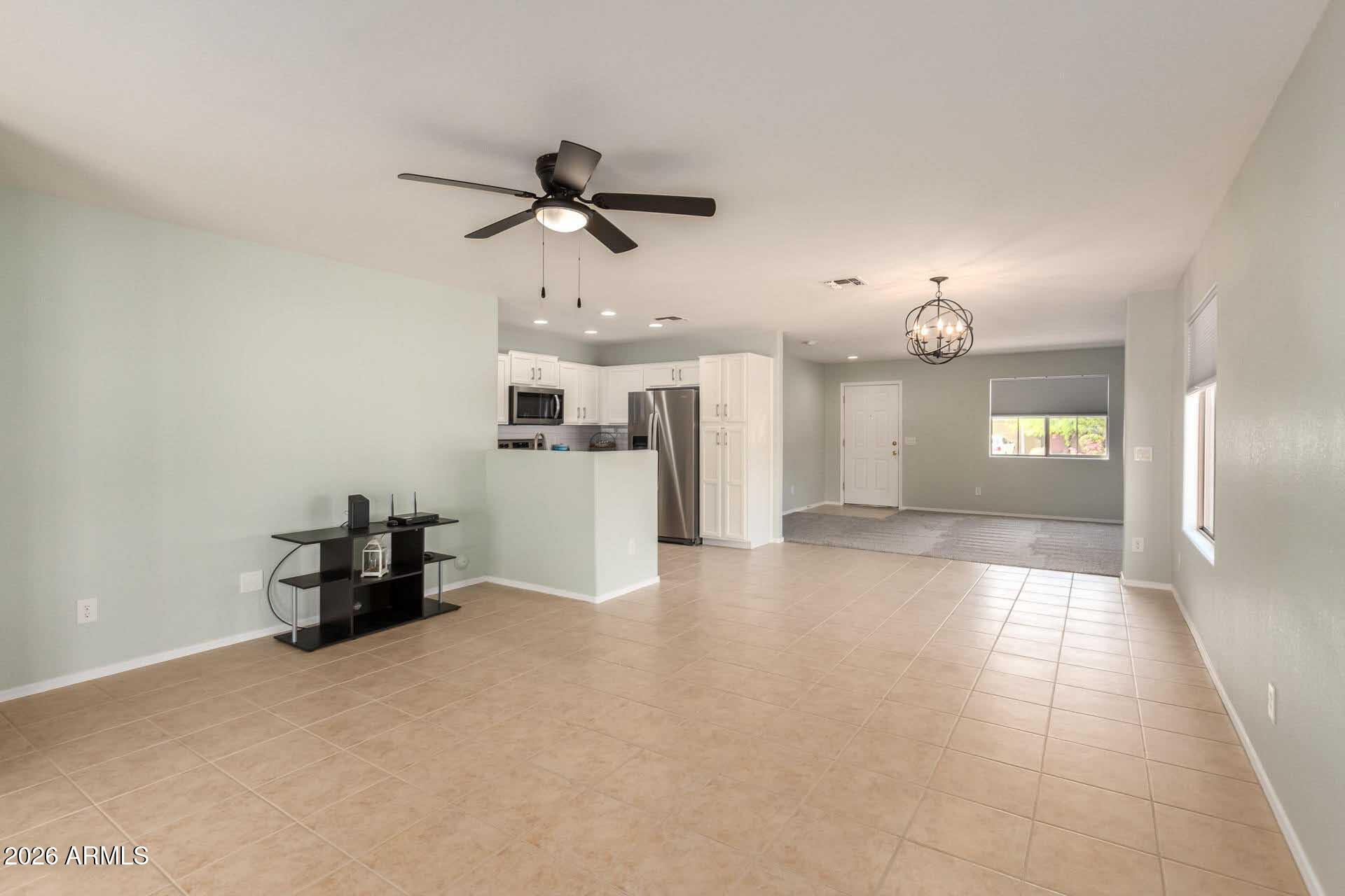 17618 West Calavar Road Surprise, AZ 85388 - Photo 8 of 24 a view of a livingroom with furniture and a kitchen