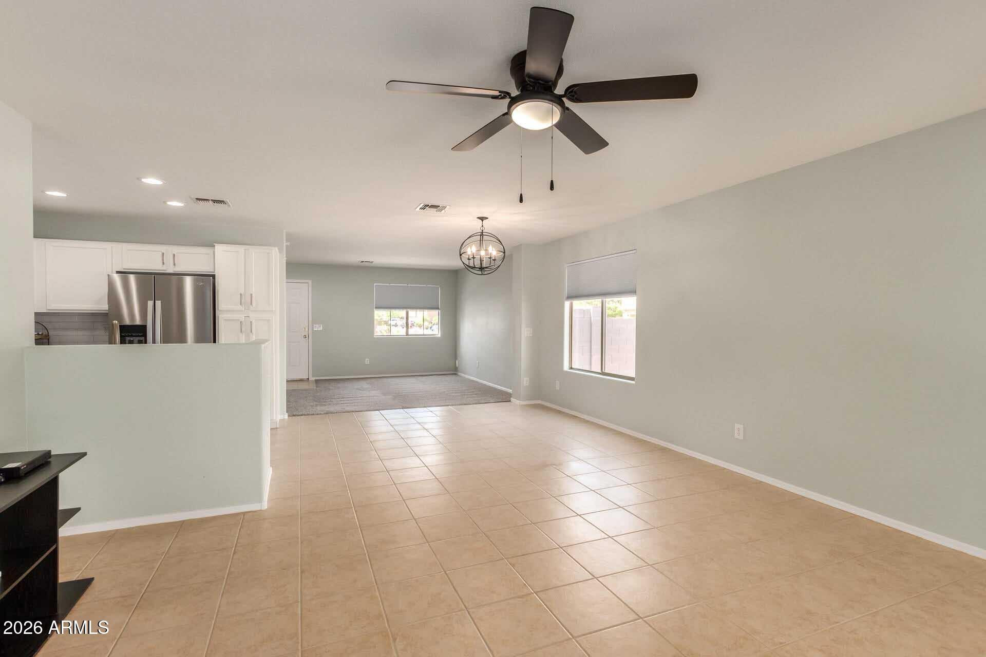 17618 West Calavar Road Surprise, AZ 85388 - Photo 9 of 24 a view of an empty room with a window