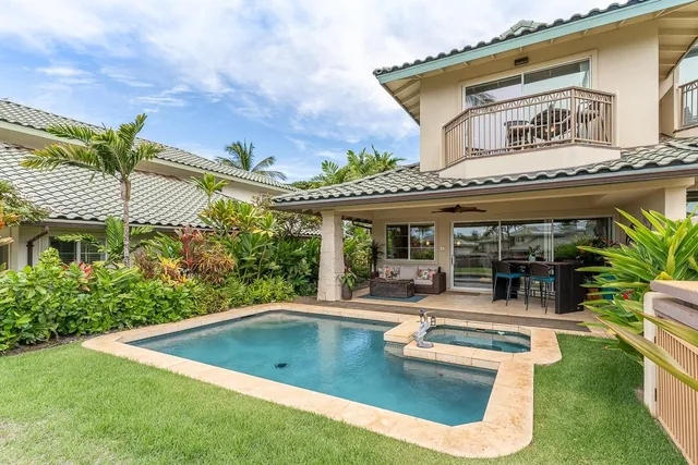a view of a pool in a backyard